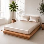 Minimalist bedroom with a wooden platform bed, white bedding, and potted plants.