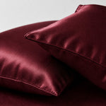Two marron pillows displayed closely, highlighting their deep hue and plush fabric