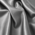 A close-up of draped satin fabric with a smooth, lustrous finish and soft folds.