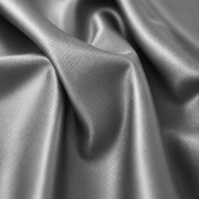 A close-up of draped satin fabric with a smooth, lustrous finish and soft folds.