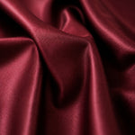 Detailed view of wine satin fabric, highlighting its glossy surface and deep color