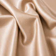 Smooth sand satin fabric with graceful folds and a soft sheen, conveying elegance and luxury. The light gently highlights its silky texture.